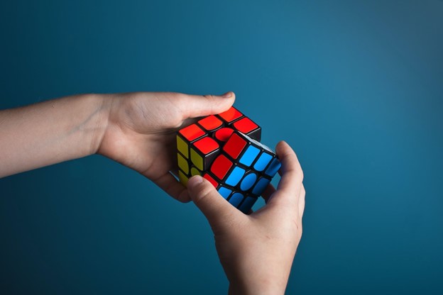 someone is playing with rubix cube, with coaching business can find what works for them